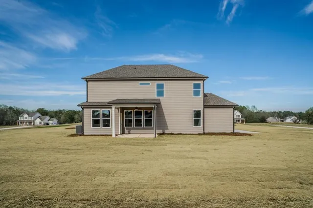 a front view of a house with yard and garage