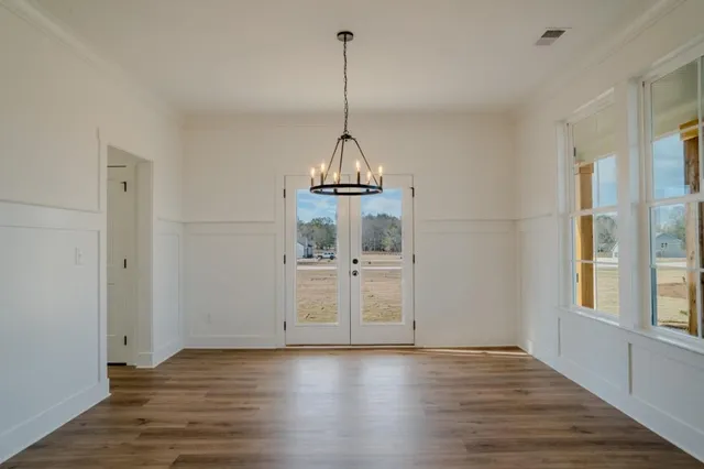 a view of a room with wooden floor and windows