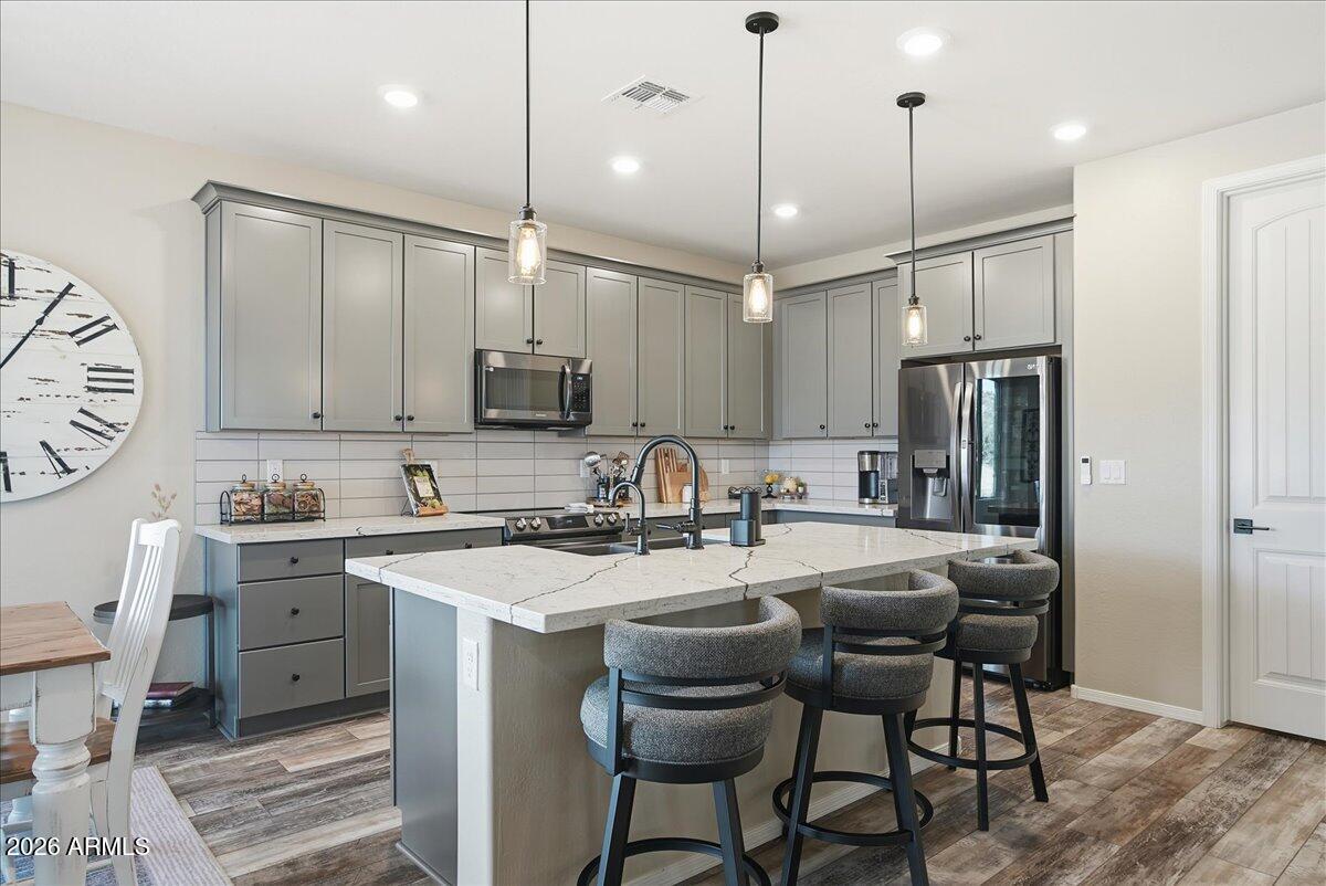 6150 North Stratford Court Rimrock, AZ 86335 - Photo 15 of 60 a kitchen with stainless steel appliances granite countertop a sink a stove a refrigerator cabinets and chairs