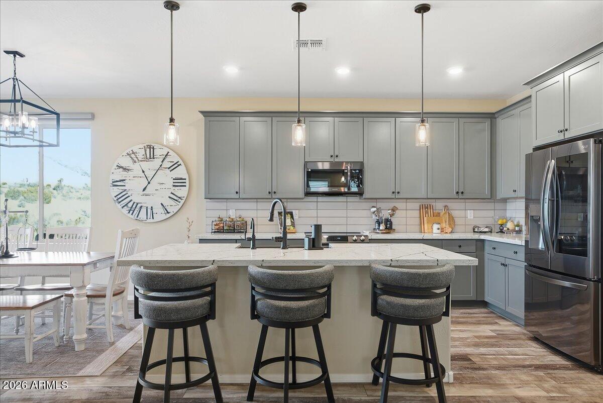 6150 North Stratford Court Rimrock, AZ 86335 - Photo 16 of 60 a kitchen with stainless steel appliances granite countertop a sink a stove a refrigerator cabinets and chairs