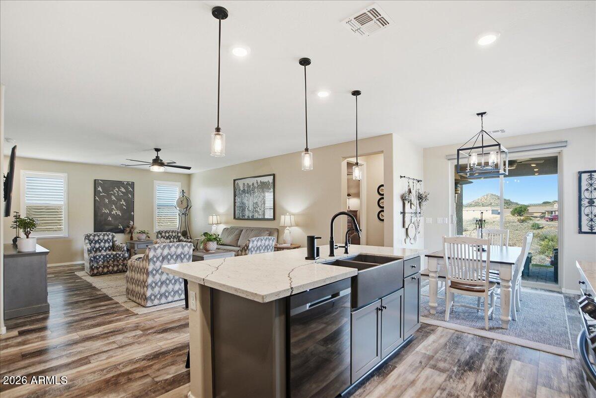 6150 North Stratford Court Rimrock, AZ 86335 - Photo 18 of 60 a large kitchen with kitchen island a sink a counter space and living room view