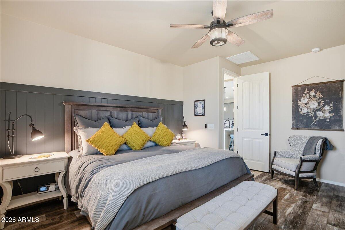 6150 North Stratford Court Rimrock, AZ 86335 - Photo 24 of 60 a bedroom with a bed a chair and a chandelier