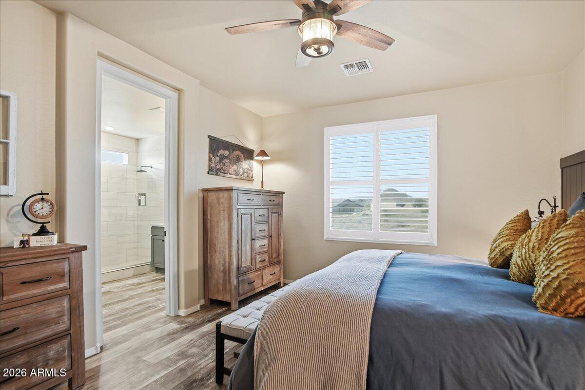 6150 North Stratford Court Rimrock, AZ 86335 - Photo 25 of 60 a bedroom with a bed and a chandelier