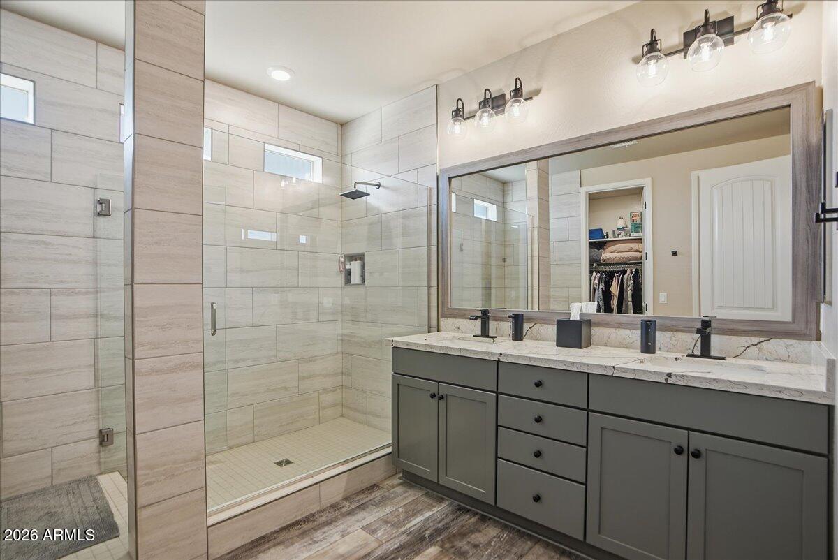 6150 North Stratford Court Rimrock, AZ 86335 - Photo 26 of 60 a bathroom with a double vanity sink mirror and shower