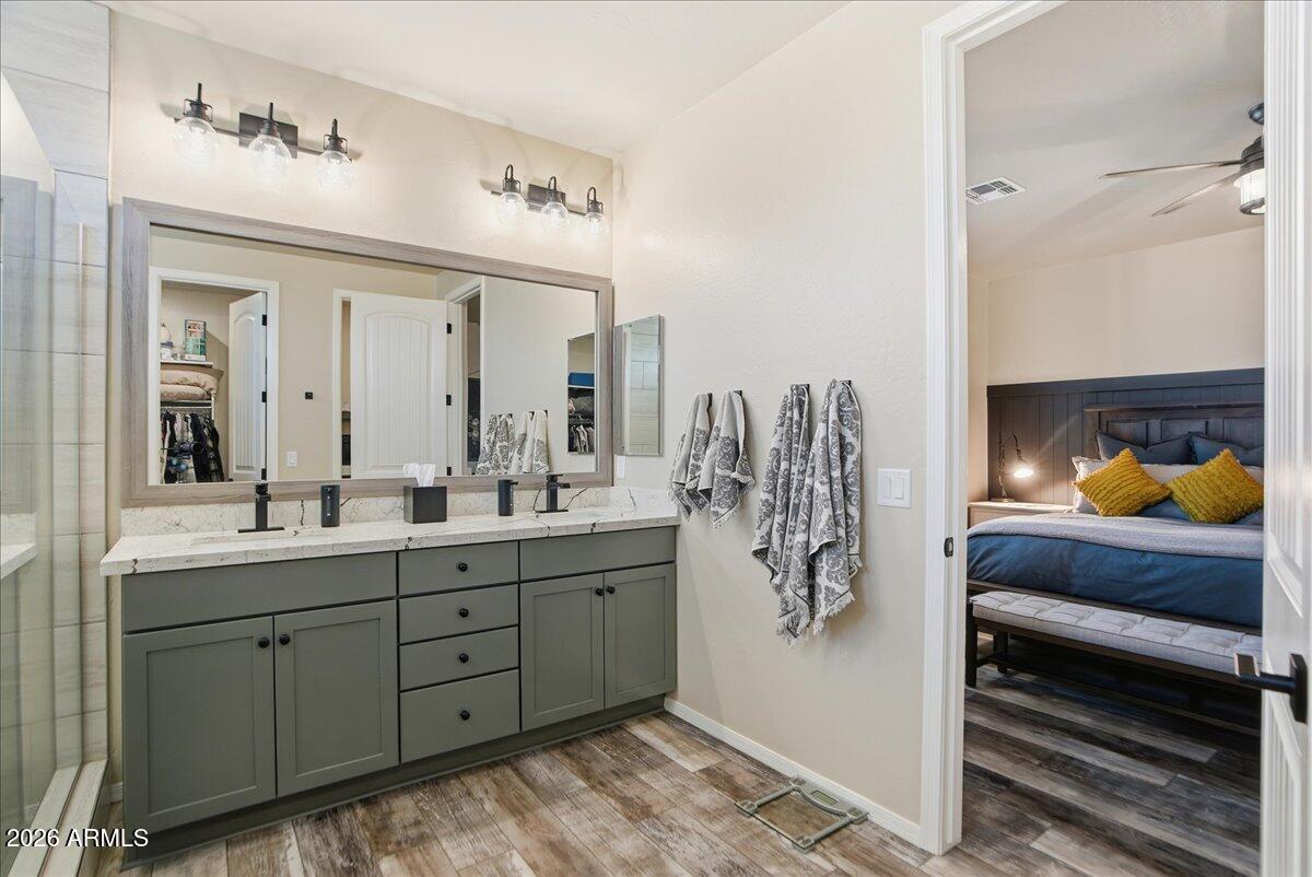 6150 North Stratford Court Rimrock, AZ 86335 - Photo 27 of 60 a en suite bathroom with a double vanity sink and mirror