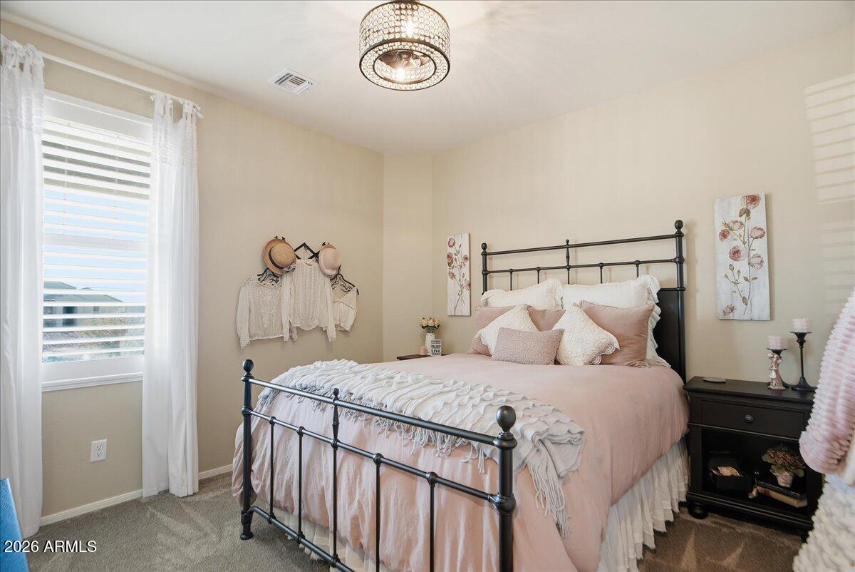 6150 North Stratford Court Rimrock, AZ 86335 - Photo 29 of 60 a bedroom with a bed and a chandelier