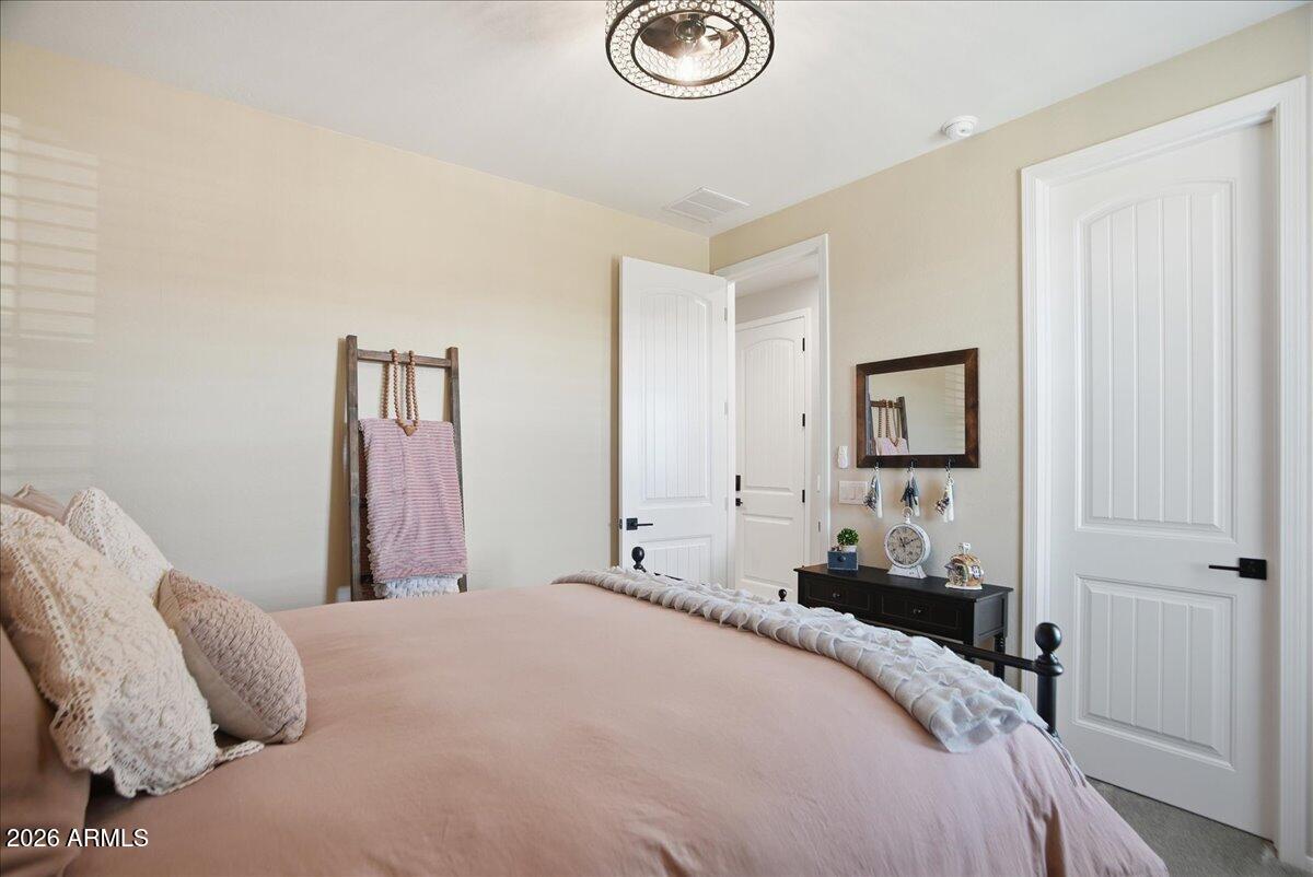 6150 North Stratford Court Rimrock, AZ 86335 - Photo 30 of 60 a bedroom with a bed and a chandelier