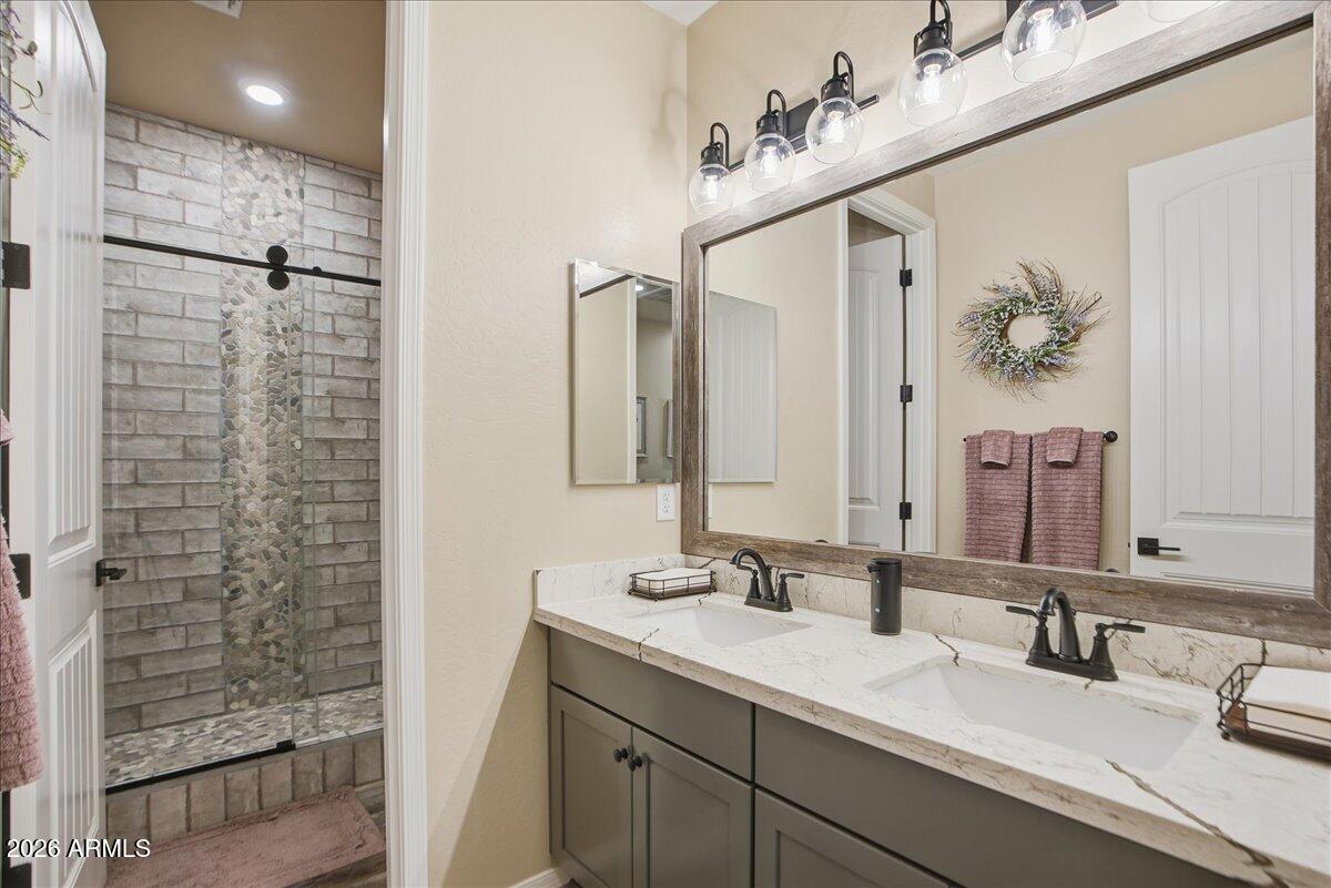 6150 North Stratford Court Rimrock, AZ 86335 - Photo 31 of 60 a bathroom with a double vanity sink and a mirror
