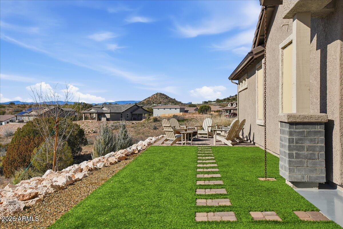 6150 North Stratford Court Rimrock, AZ 86335 - Photo 35 of 60 a view of a patio with table and chairs with wooden floor and fence