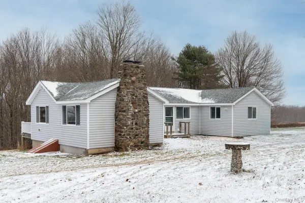 a house that has a tree in front of it
