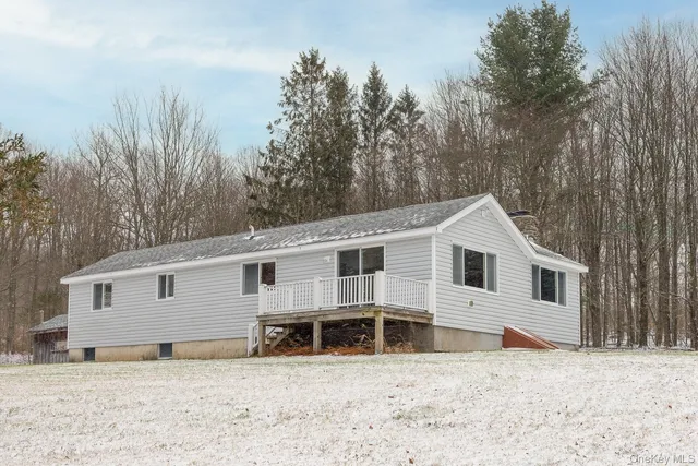 a view of a house with a yard covered in snow
