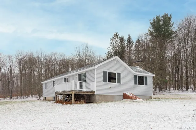 a view of a house with a yard covered in snow