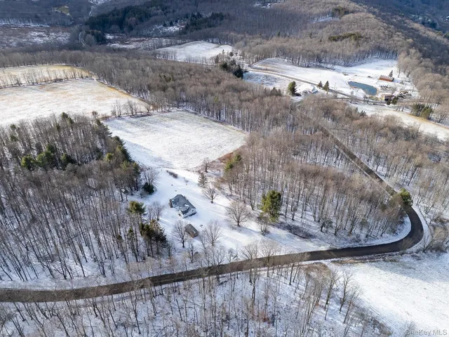 a view of a dry yard with wooden fence
