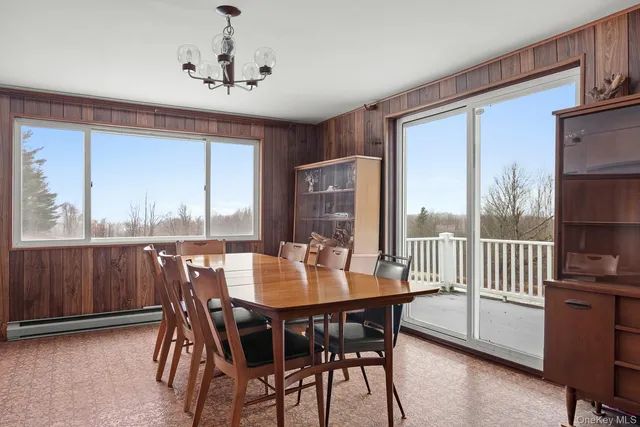 a view of a dining room with furniture window and outside view