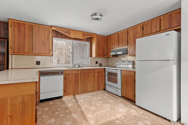 a kitchen with white cabinets sink and white appliances