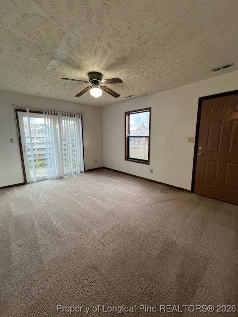 164 Eulon Loop, Unit A & B Raeford, NC 28376 - Photo 3 of 12 an empty room with windows and chandelier fan