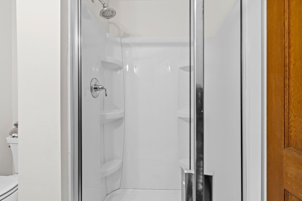 24 Vaille Avenue Lexington, MA 02421 - Photo 18 of 41 a bathroom with a glass shower door