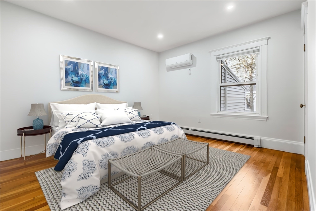 24 Vaille Avenue Lexington, MA 02421 - Photo 19 of 41 a bedroom with a bed and wooden floor