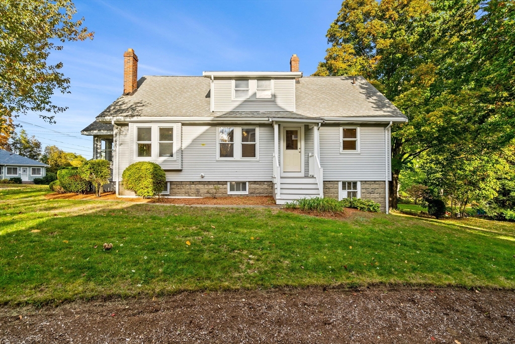 24 Vaille Avenue Lexington, MA 02421 - Photo 2 of 41 a view of a white house with a big yard plants and large trees