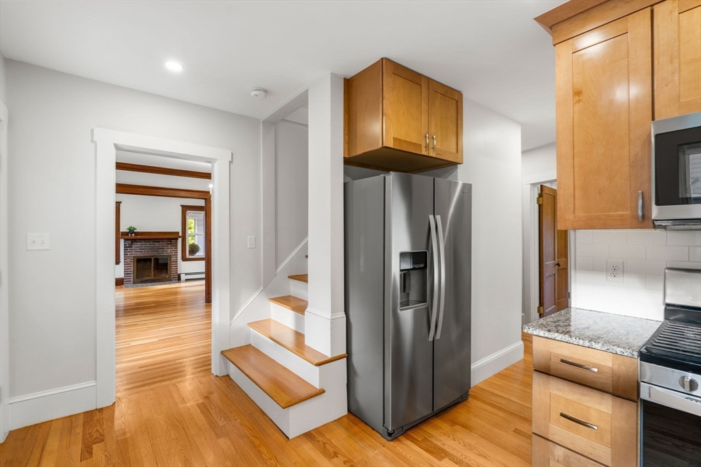24 Vaille Avenue Lexington, MA 02421 - Photo 22 of 41 a view of a hallway with wooden floor and living room