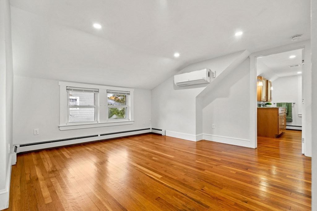 24 Vaille Avenue Lexington, MA 02421 - Photo 25 of 41 a view of empty room with wooden floor and fan