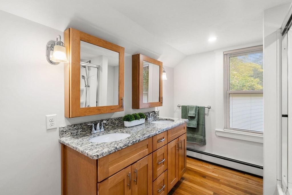 24 Vaille Avenue Lexington, MA 02421 - Photo 26 of 41 a bathroom with a granite countertop sink and a mirror