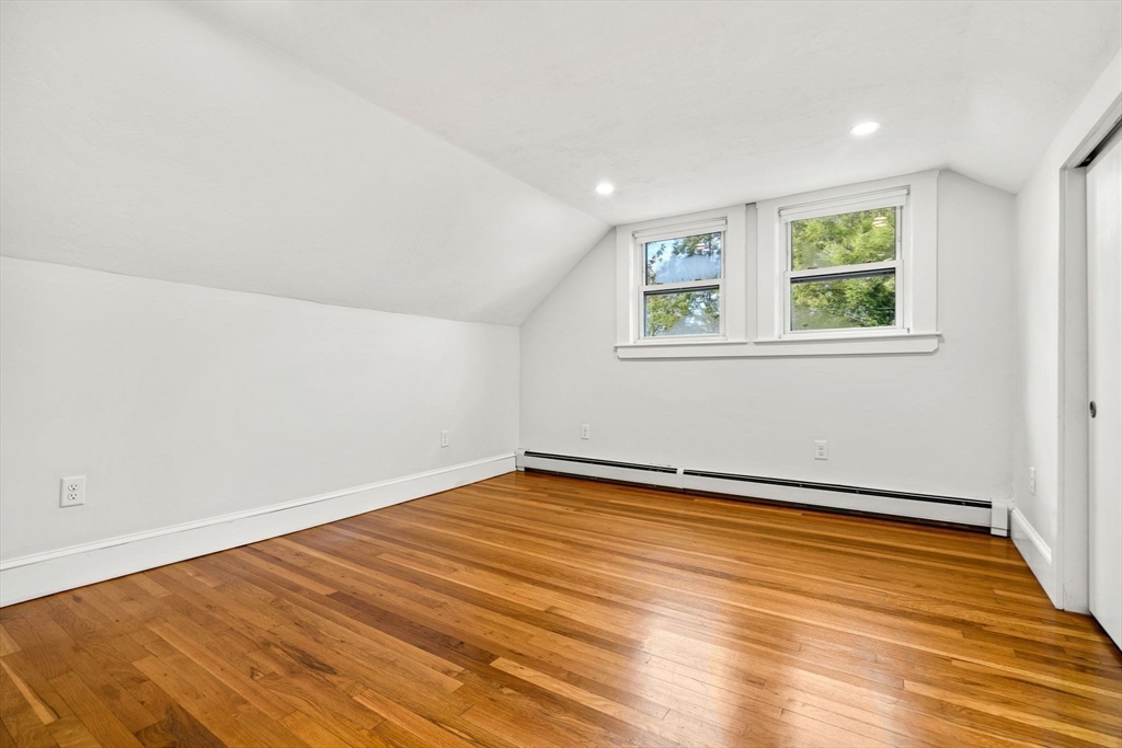 24 Vaille Avenue Lexington, MA 02421 - Photo 29 of 41 a view of an empty room with wooden floor and a window