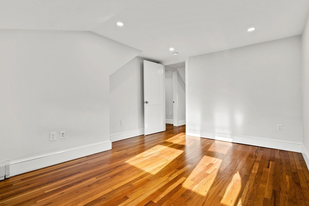 24 Vaille Avenue Lexington, MA 02421 - Photo 31 of 41 a view of room with wooden floor and white walls