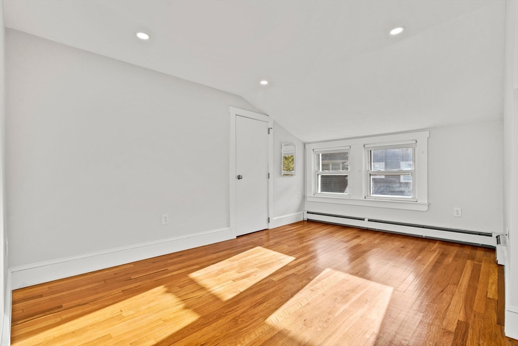 24 Vaille Avenue Lexington, MA 02421 - Photo 32 of 41 a view of a room with wooden floor and white walls