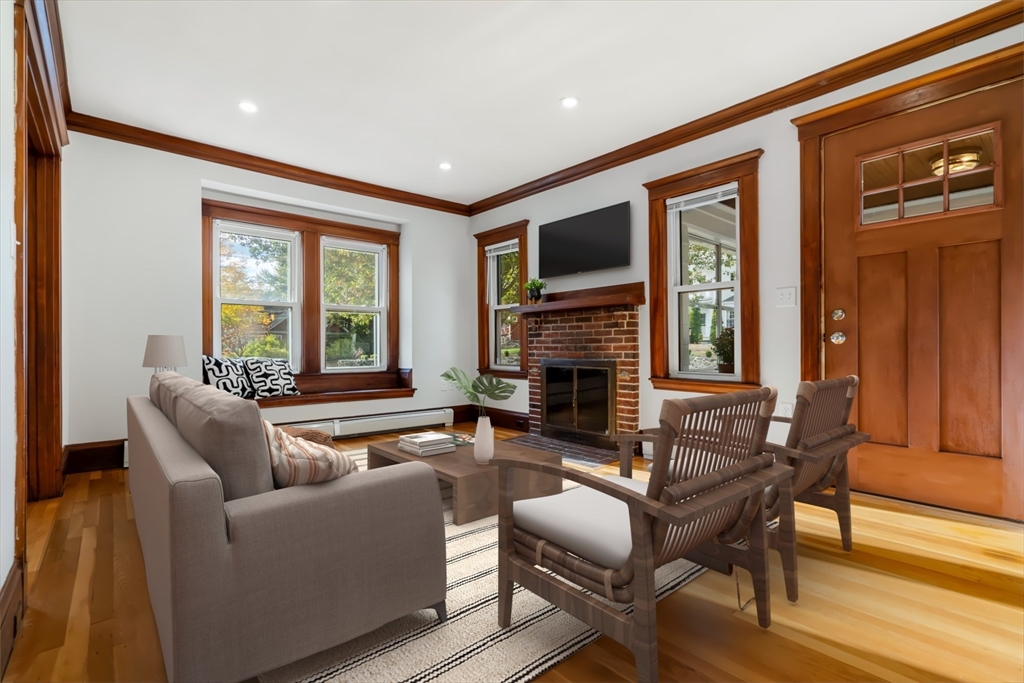 24 Vaille Avenue Lexington, MA 02421 - Photo 7 of 41 a living room with furniture a flat screen tv and a fireplace