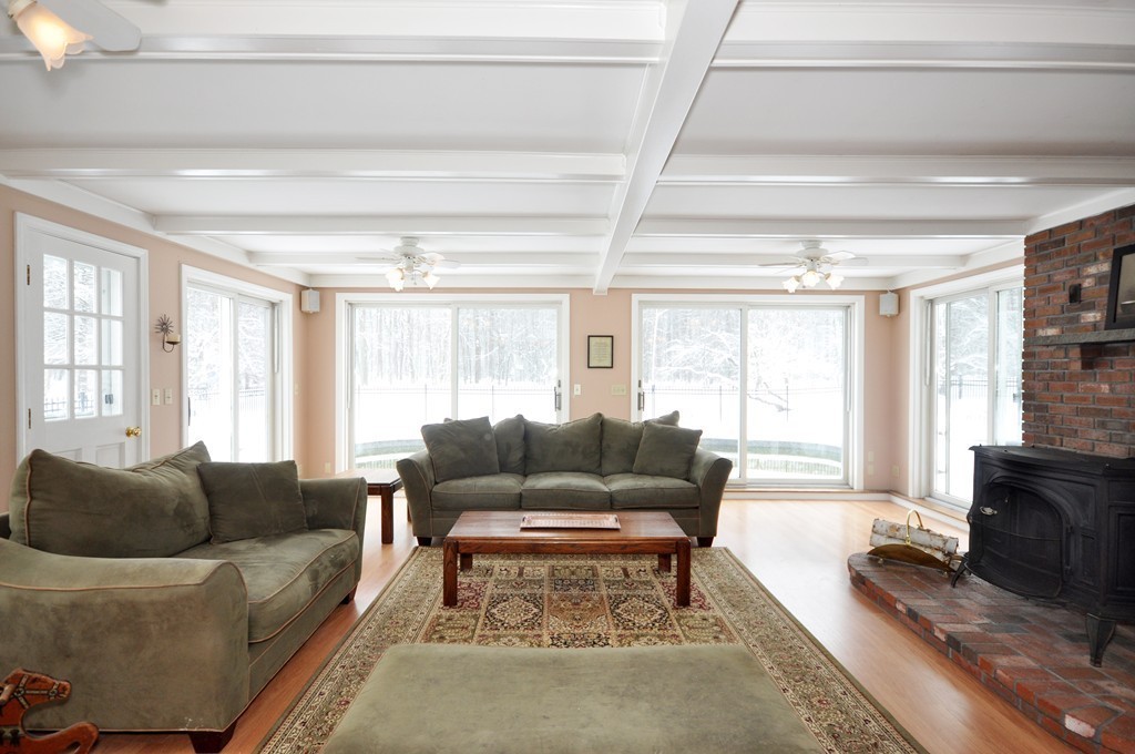 33 Warner Road Bolton, MA 01740 - Photo 2 of 23 a living room with furniture and a flat screen tv