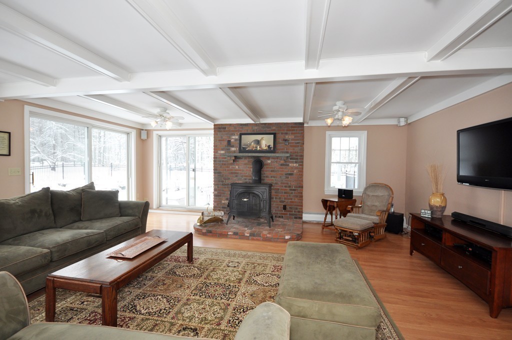 33 Warner Road Bolton, MA 01740 - Photo 5 of 23 a living room with furniture large window and a flat screen tv