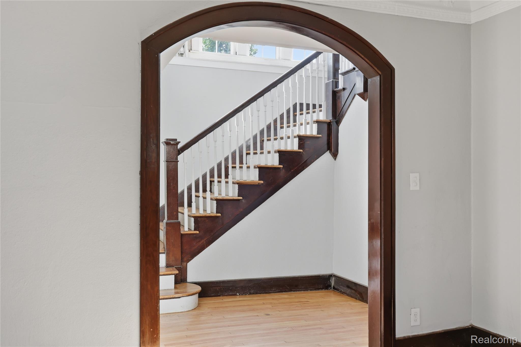 1945 Atkinson Street Detroit, MI 48206 - Photo 14 of 49 Archway entry framing a prominent wooden staircase