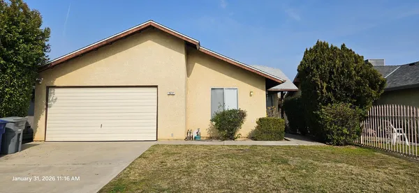 a view of a house with a yard and garage