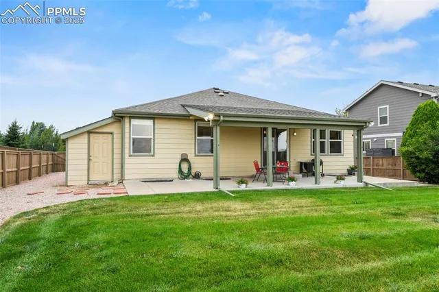a front view of house with a garden and patio