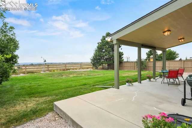 a view of a backyard with sitting area