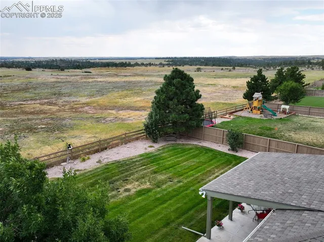 a view of a terrace with a garden and lake view