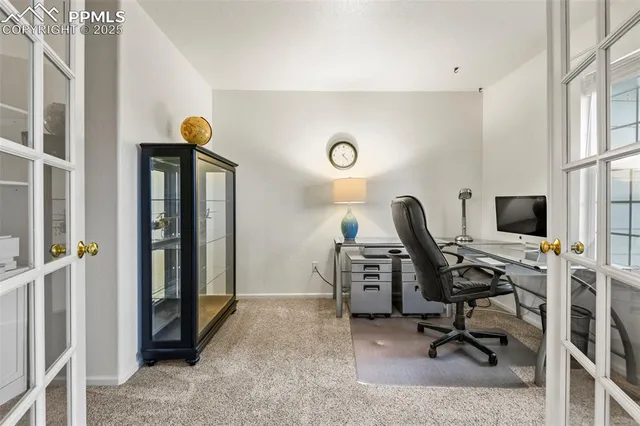 a view of a workspace with furniture and a window