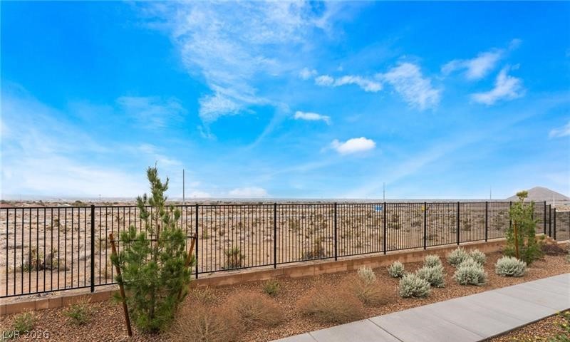 6212 Rathbone Street Las Vegas, NV 89166 - Photo 21 of 22 An expansive fenced desert landscape provides a vast and serene private outlook.