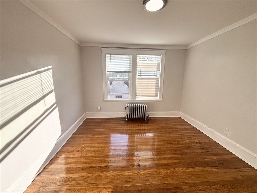 36 Spring Street, Unit 11 Malden, MA 02148 - Photo 9 of 12 a view of empty room with wooden floor and fan