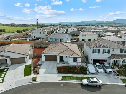 an aerial view of a building with outdoor space and ocean view
