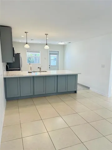 a kitchen with granite countertop a sink and a stove top oven