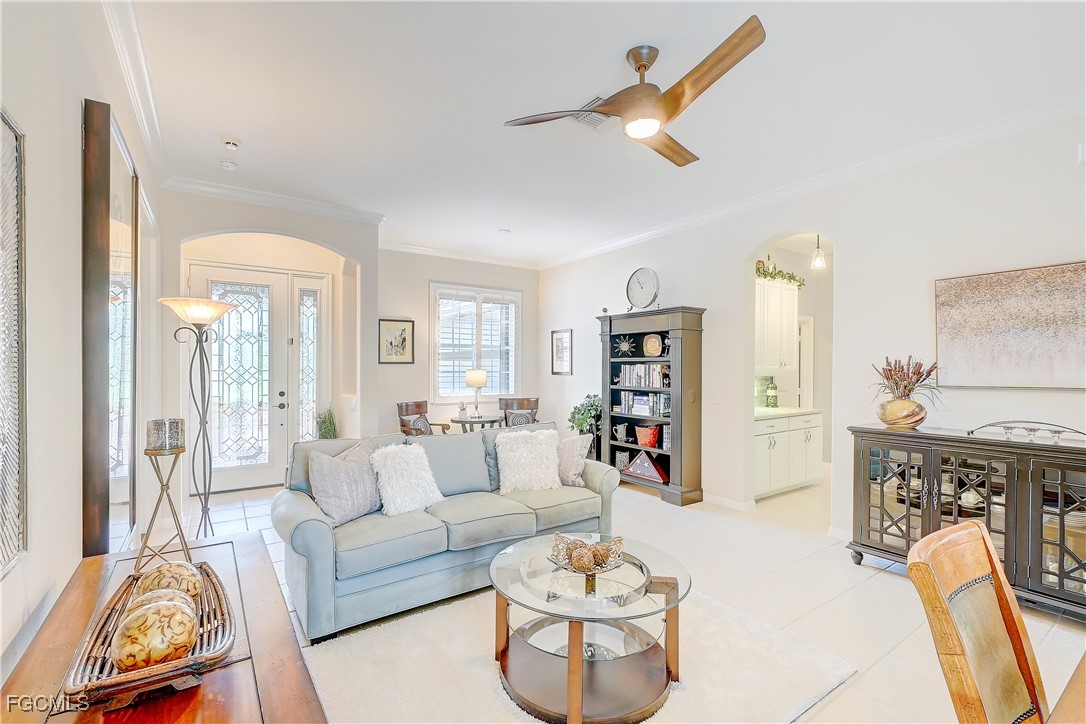 12910 Timber Ridge Drive Fort Myers, FL 33913 - Photo 5 of 37 a living room with furniture a rug and white walls