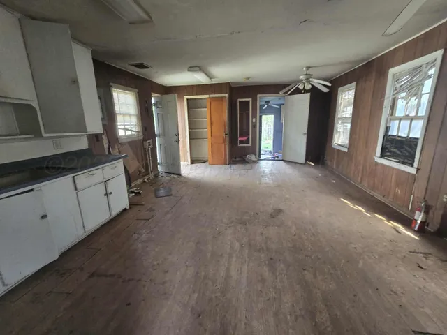 a view of hallway with furniture and windows