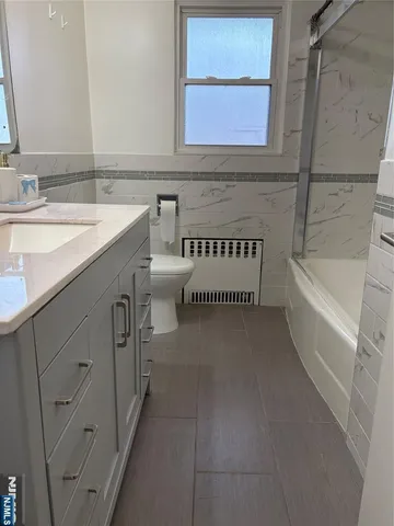 a bathroom with a sink a vanity and a bathtub