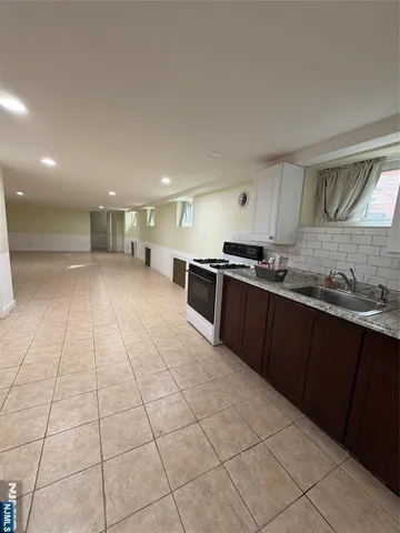 a kitchen with stainless steel appliances granite countertop a sink and cabinets