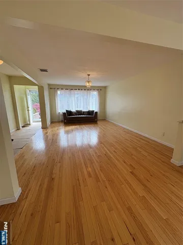 a view of a room with wooden floor and fireplace