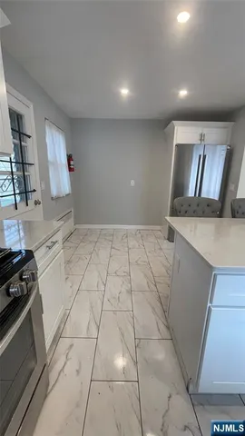 a view of a kitchen with a sink stove and cabinets