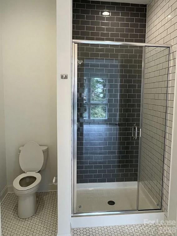 19546 Greentree Way, Unit 203 Cornelius, NC 28031 - Photo 16 of 22 a bathroom with a toilet and a shower