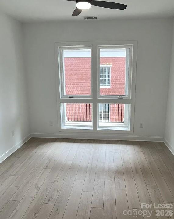19546 Greentree Way, Unit 203 Cornelius, NC 28031 - Photo 19 of 22 a view of an empty room with wooden floor and a window